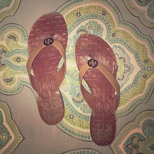 Brown Tory Burch flip flops.